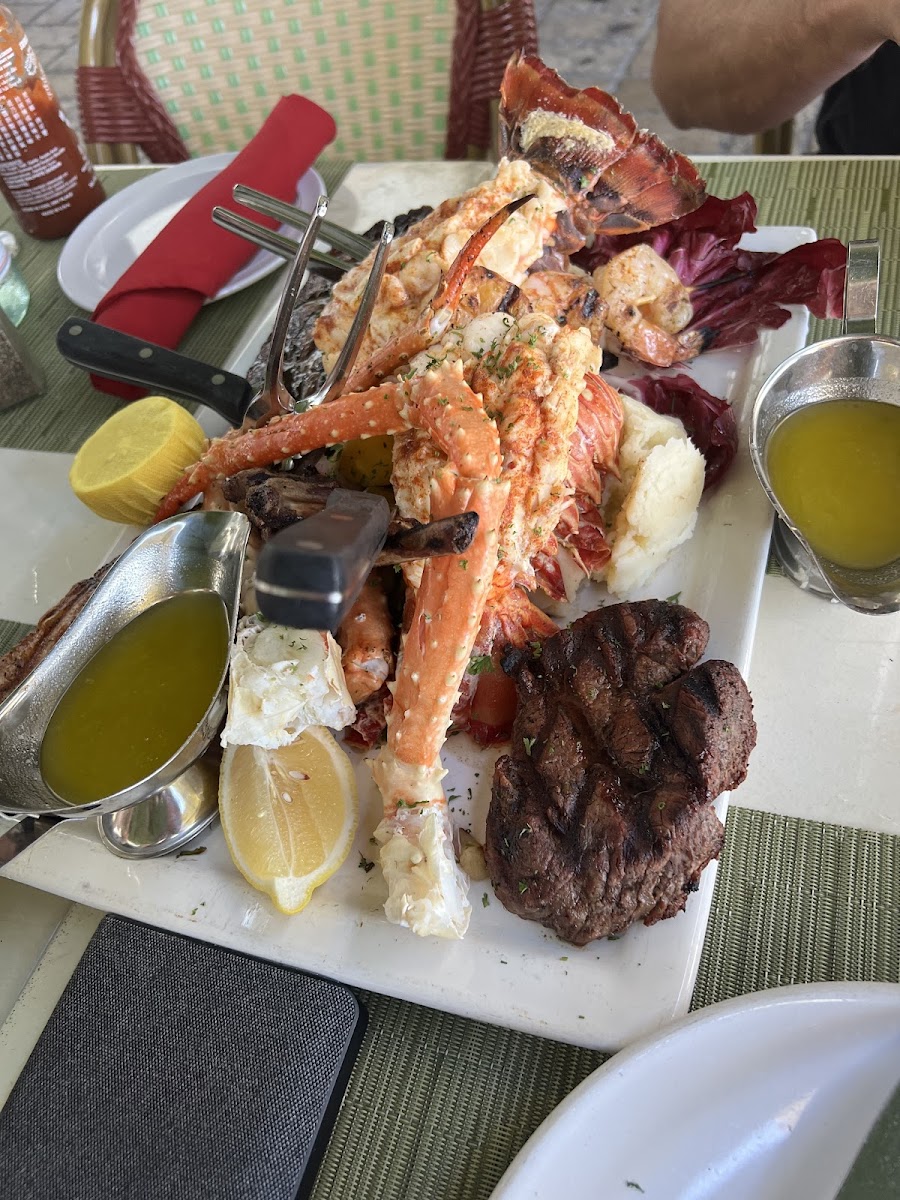 Seafood and steak platter with sauces