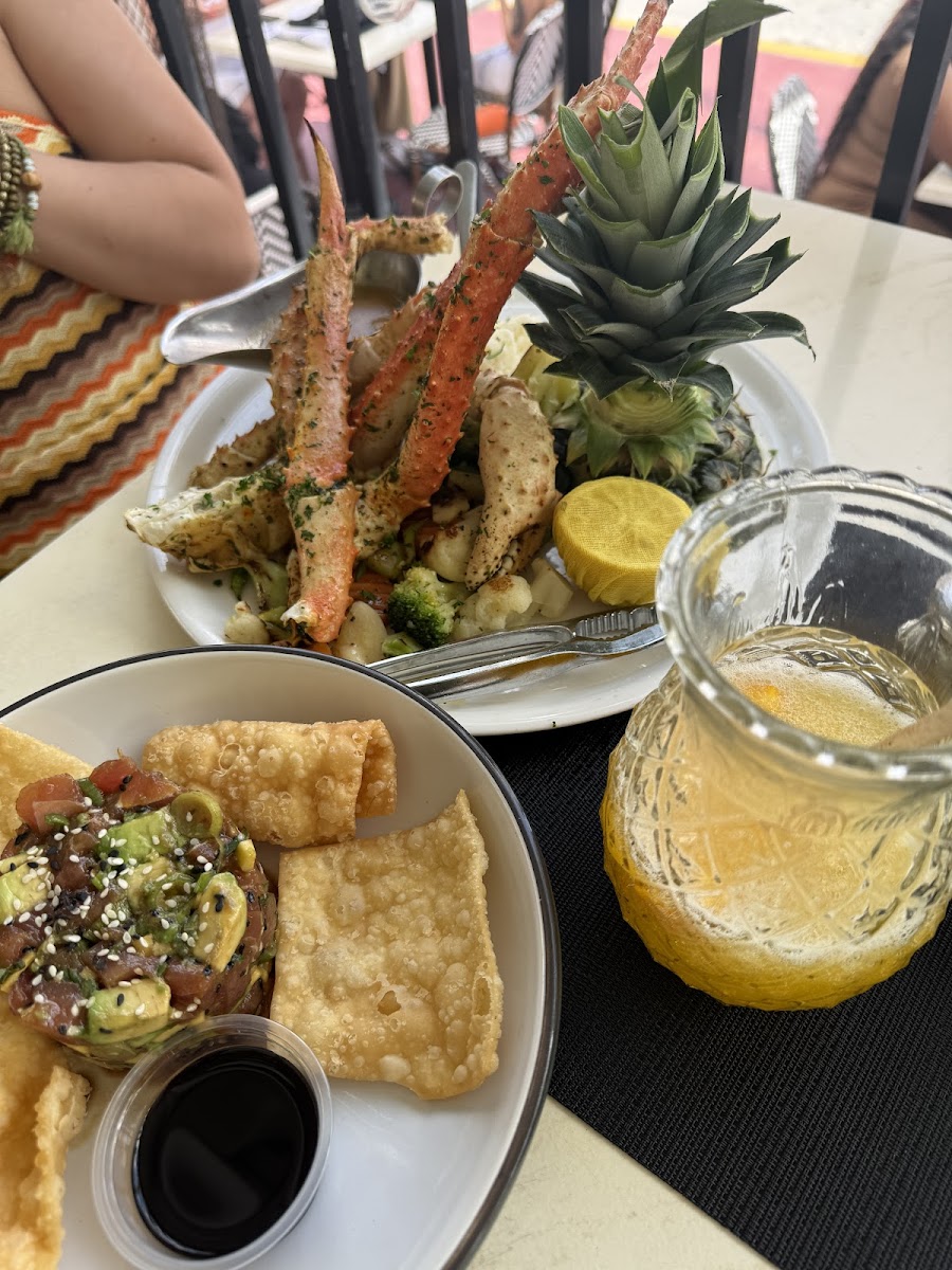 Crab legs and poke bowl on table